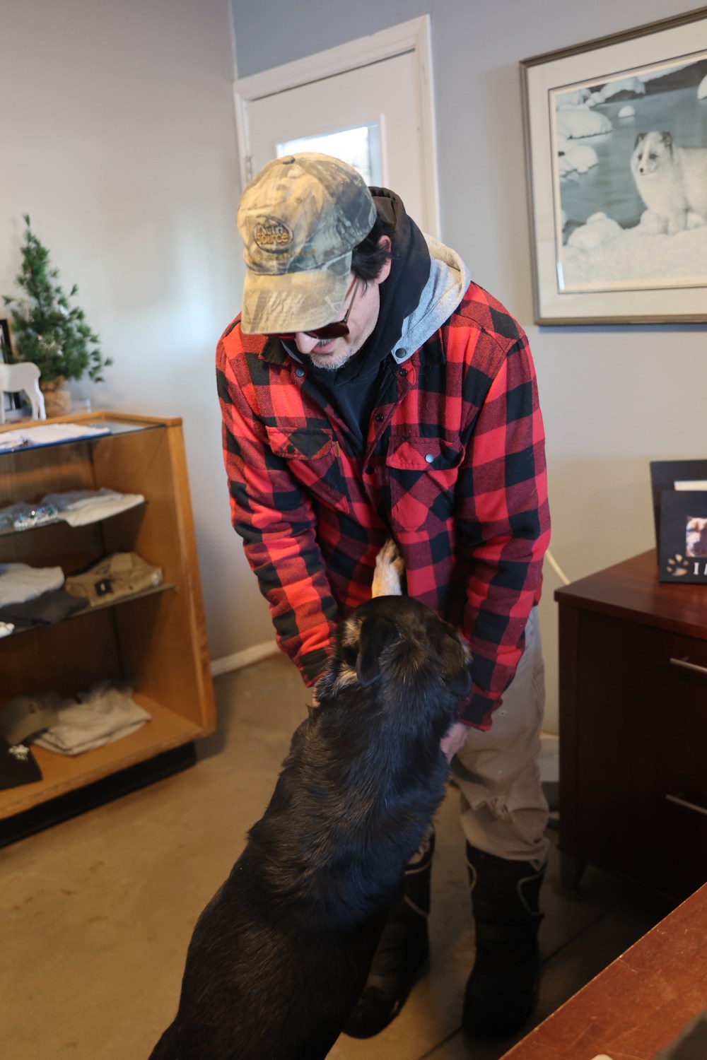 Brandon Humane Society adoption counsellor Brian Simard gets a cuddle from one of the adoptable dogs. (Kyla Henderson/The Brandon Sun)