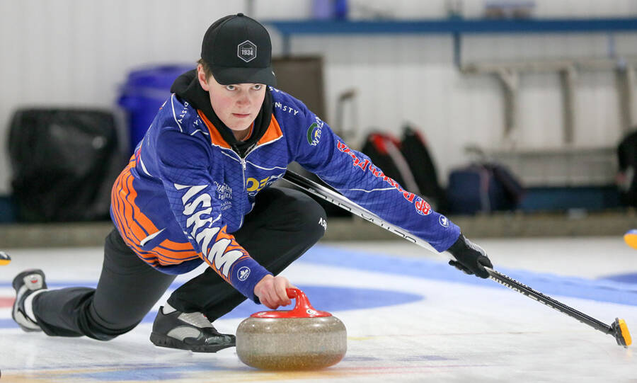Altona skip Rylan Campbell of Brandon is a study in concentration as he sends a rock, looking to use his draw game in the championship game his foursome won 11-1 facing Morden skip Nash Sugden's foursome. (Photo courtesy CurlManitoba)