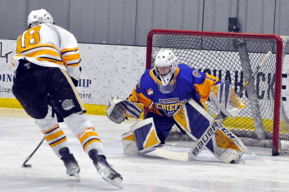 Yellowhead Chiefs rookie goalie Kieran Madill stares down Brandon Wheat Kings forward Colten Worthington (18) during first period action. Madill made the save, but trailing Brandon forward Loughlan McMullan scored the first of his four goals off the rebound.