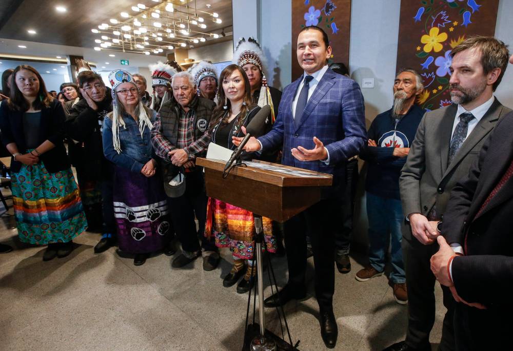 Members of the Seal River Watershed Alliance (left) and federal Environment and Climate Change Minister Steven Guilbeault (right) — the minister responsible for Parks Canada — listen in as Manitoba Premier Wab Kinew speaks at a press conference in Winnipeg on Thursday. Representatives from the federal and provincial governments signed a memorandum of understanding with the Seal River Watershed Alliance, made up of local indigenous communities, to protect the northern Manitoba watershed. (The Canadian Press)