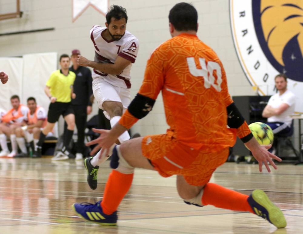Assiniboine Community College Cougars Rafael Priolo takes a shot on Brandon University goalkeeper Zsombor Deak during MCAC men's futsal action at Henry Champ Gymnasium on Saturday. Brandon won 3-2. (Thomas Friesen/The Brandon Sun)