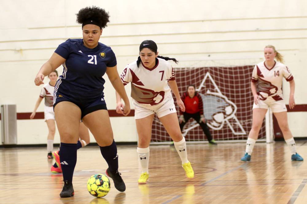 Brandon University Bobcats Deja Newell (21) controls the ball with ACC's Elsy Benitez defending during MCAC women's futsal action at ACC on Saturday. Brandon prevailed 11-1. (Thomas Friesen/The Brandon Sun)