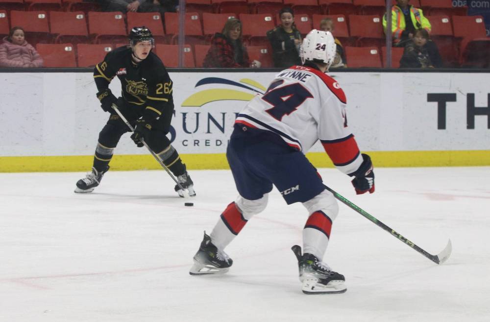 Brandon Wheat Kings forward Nick Johnson (26) carries the puck into the Lethbridge Hurricanes zone under the watchful eye of defender Braeden Wynne (24) during his Wheat Kings debut on Saturday.