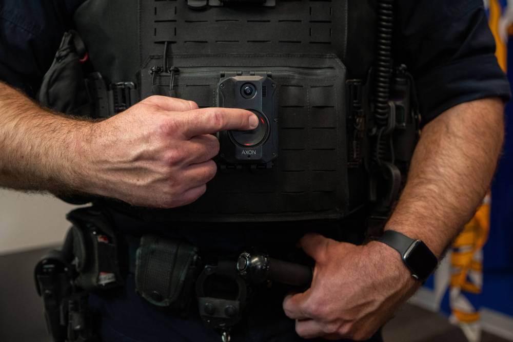 A police officer demonstrates recording on a body camera during a news conference in Surrey, B.C., on Jan. 11. With police body cameras expected to arrive in Brandon this summer, Brandonites could help to develop accountability policies to include serious penalties for improper police use of the devices, Christopher Schneider writes. (File)