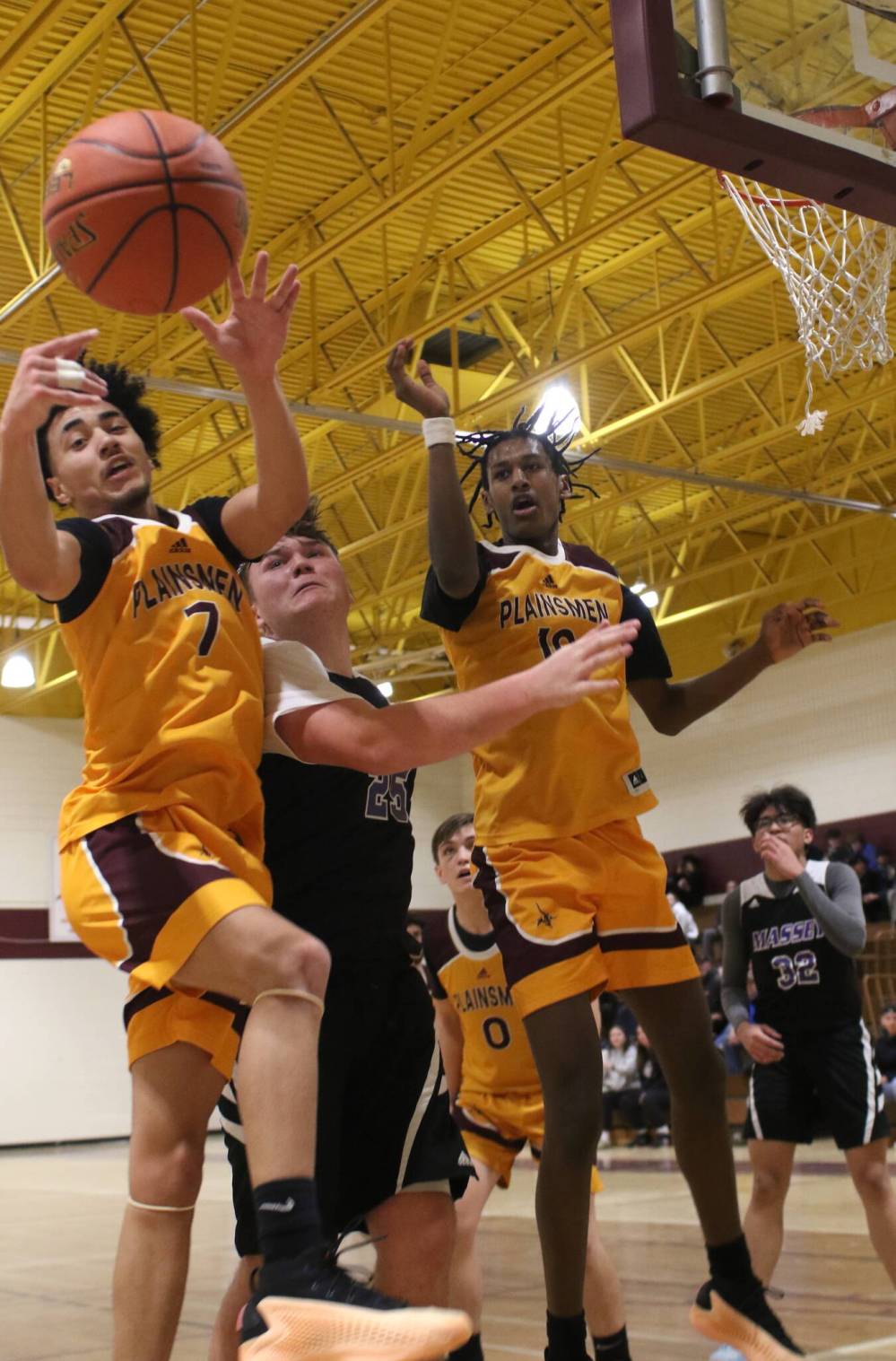 Christian Martin-Murray, left, Noah Mulaw of the Crocus Plainsmen and Scott Sherb of the Vincent Massey Vikings watch as a rebound flies out of bounds.