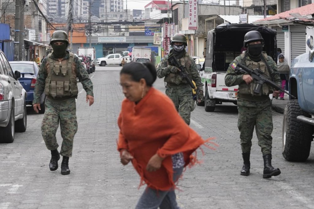 Soldiers patrol the perimeter of Inca prison during a state of emergency in Quito, Ecuador, Tuesday, Jan. 9, 2024, in the wake of the apparent escape of a powerful gang leader from prison. President Daniel Noboa decreed Monday a national state of emergency, a measure that lets authorities suspend people’s rights and mobilize the military in places like the prisons. The government also imposed a curfew from 11 p.m. to 5 a.m. (AP Photo/Dolores Ochoa)