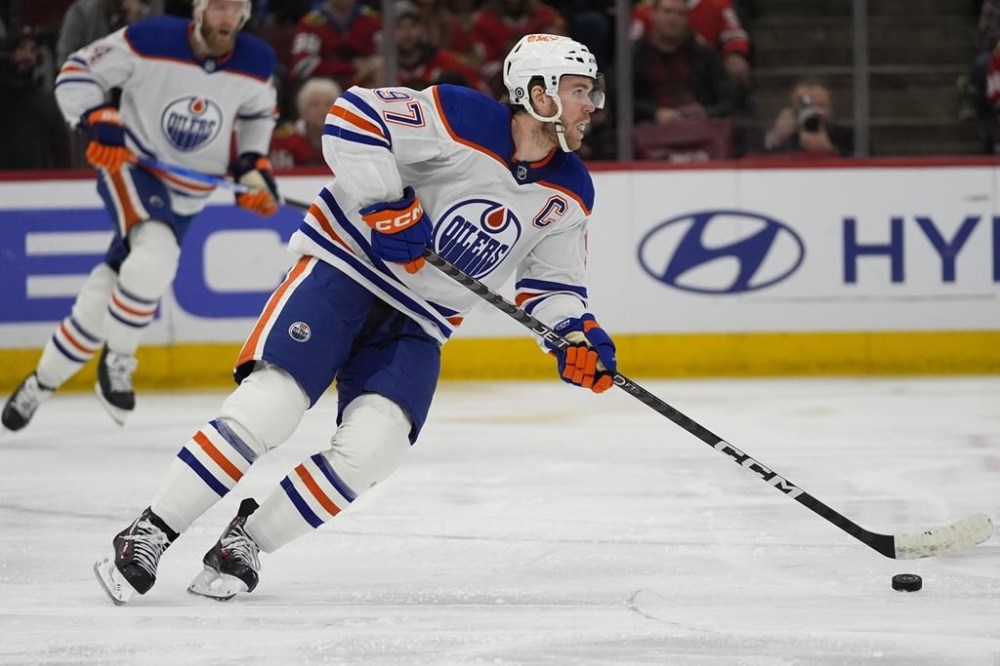 Edmonton Oilers center Connor McDavid handles the puck during the second period of the team's NHL hockey game against the Chicago Blackhawks on Tuesday, Jan. 9, 2024, in Chicago. (AP Photo/Erin Hooley)