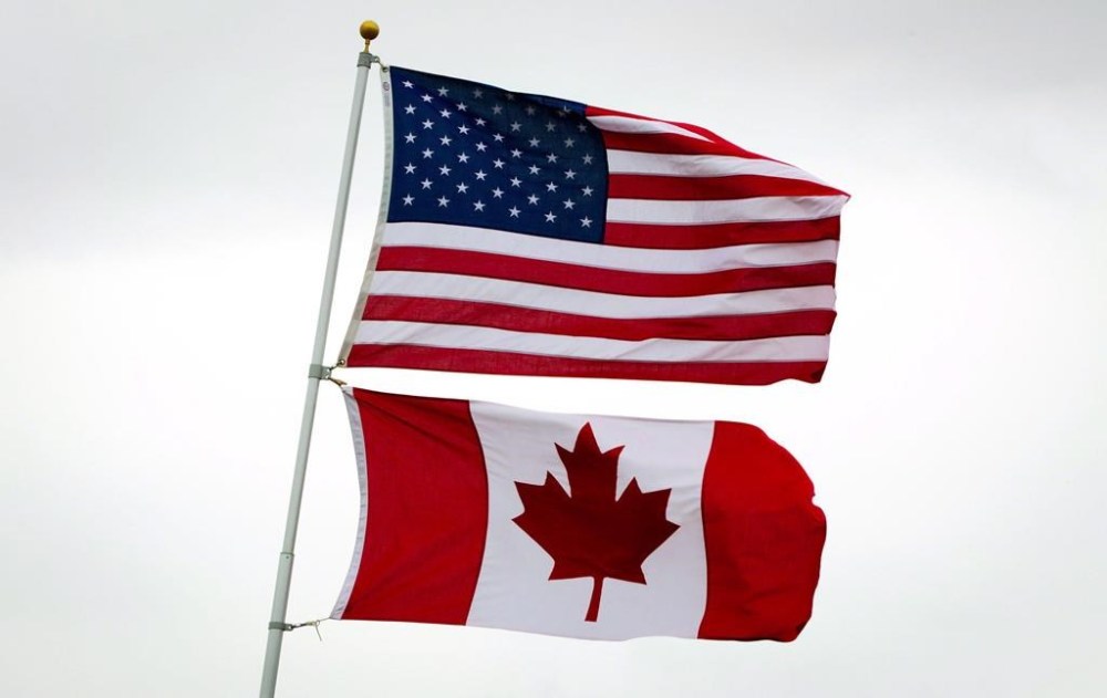The union that represents Canadian diplomats abroad says Global Affairs Canada should consider boosting compensation for those posted to the United States because they face increased risk of gun crime and difficulty accessing health care. U.S. and Canadian flags fly in Point Roberts, Wash., on Tuesday, March 13, 2012.THE CANADIAN PRESS/Darryl Dyck