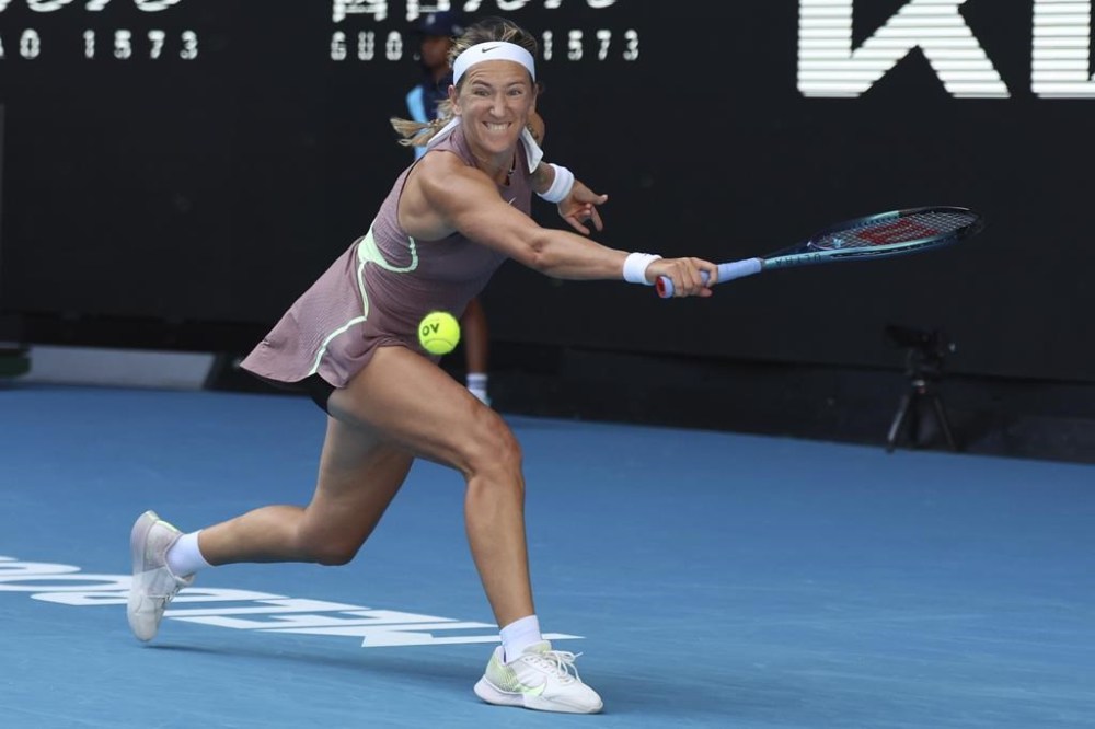 Victoria Azarenka of Belarus plays a backhand return to Jelena Ostapenko of Latvia during their third round match at the Australian Open tennis championships at Melbourne Park, Melbourne, Australia, Saturday, Jan. 20, 2024. (AP Photo/Asanka Brendon Ratnayake)