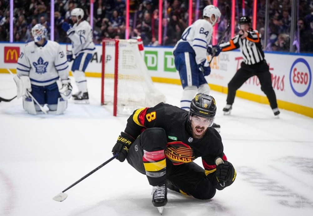 Vancouver Canucks' Conor Garland (8) celebrates his second goal against Toronto Maple Leafs goalie Martin Jones, back left, during the second period of an NHL hockey game in Vancouver, on Saturday, Jan. 20, 2024. THE CANADIAN PRESS/Darryl Dyck