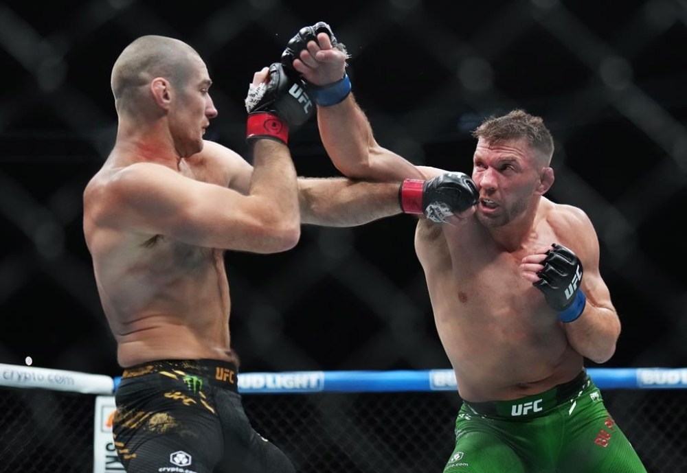 Sean Strickland, left, fights Dricus Du Plessis during a middleweight title bout at UFC 297 in Toronto on Sunday, Jan. 21, 2024. THE CANADIAN PRESS/Nathan Denette