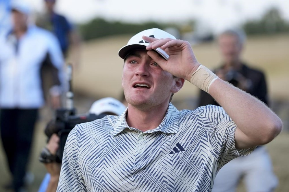 Nick Dunlap reacts after finishing on the 18th hole of the Pete Dye Stadium Course during the final round to win the American Express golf tournament, Sunday, Jan. 21, 2024, in La Quinta, Calif. (AP Photo/Ryan Sun)