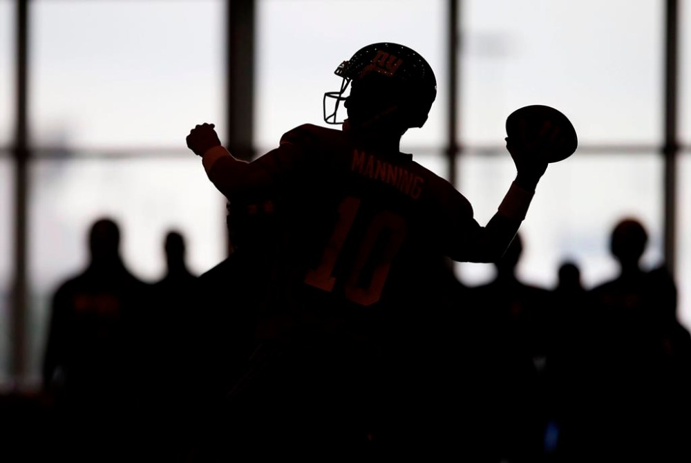 A football player is silhouetted as he throws a pass in East Rutherford, N.J. on Sunday, July 31, 2016. Canada will defend its world junior football championship when the event resumes this summer following a six-year hiatus. THE CANADIAN PRESS/AP/Rich Schultz