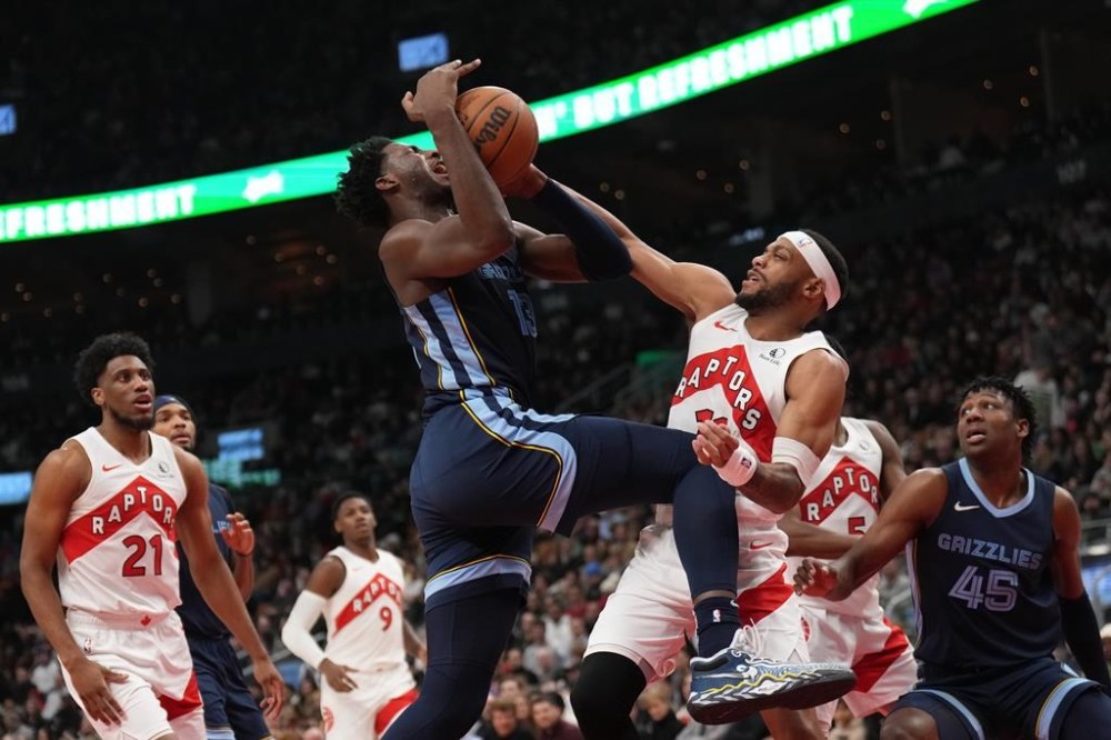 Toronto Raptors forward Bruce Brown (11) fouls Memphis Grizzlies forward Jaren Jackson Jr. (13) during first half NBA basketball action in Toronto Monday Jan. 22, 2024. THE CANADIAN PRESS/Nathan Denette