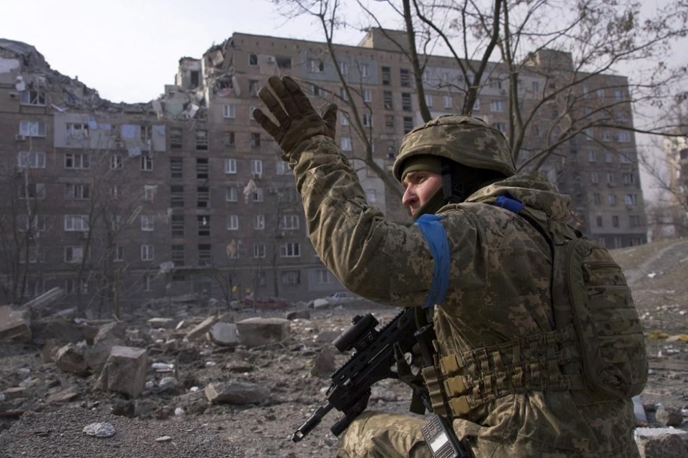 FILE - A Ukrainian serviceman guards his position in Mariupol, Ukraine, March 12, 2022. The image is part of the documentary