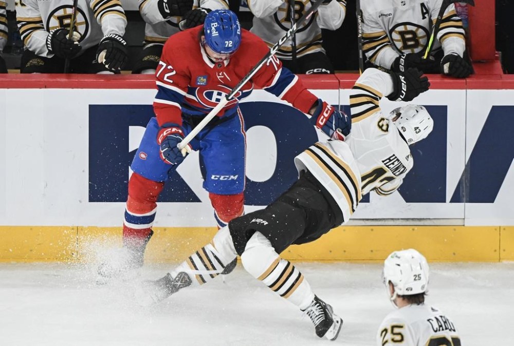 Montreal Canadiens' defenceman Arber Xhekaj (72) checks Boston Bruins' Danton Heinen during second period NHL hockey action in Montreal, Saturday, November 11, 2023. Forward Tanner Pearson and Xhekaj will return to the Montreal Canadiens lineup Tuesday night against the Ottawa Senators.THE CANADIAN PRESS/Graham Hughes