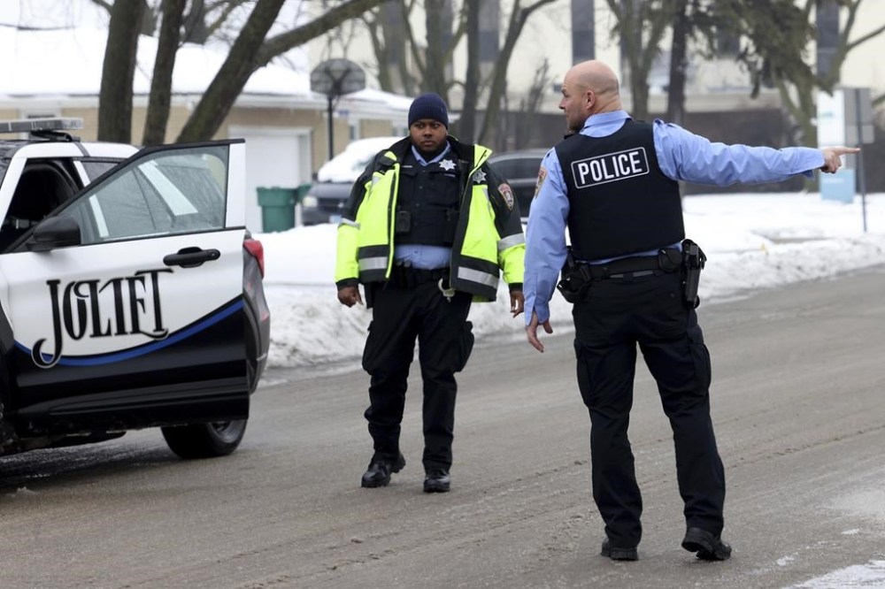 Joliet police officers work at the scene where multiple people were shot , Tuesday, Jan. 23, 2024, to death. A man suspected of shooting and killing eight people in suburban Chicago fatally shot himself after a confrontation with law enforcement officials at a gas station in Texas, where he had no known ties, authorities said. (Antonio Perez /Chicago Tribune via AP)