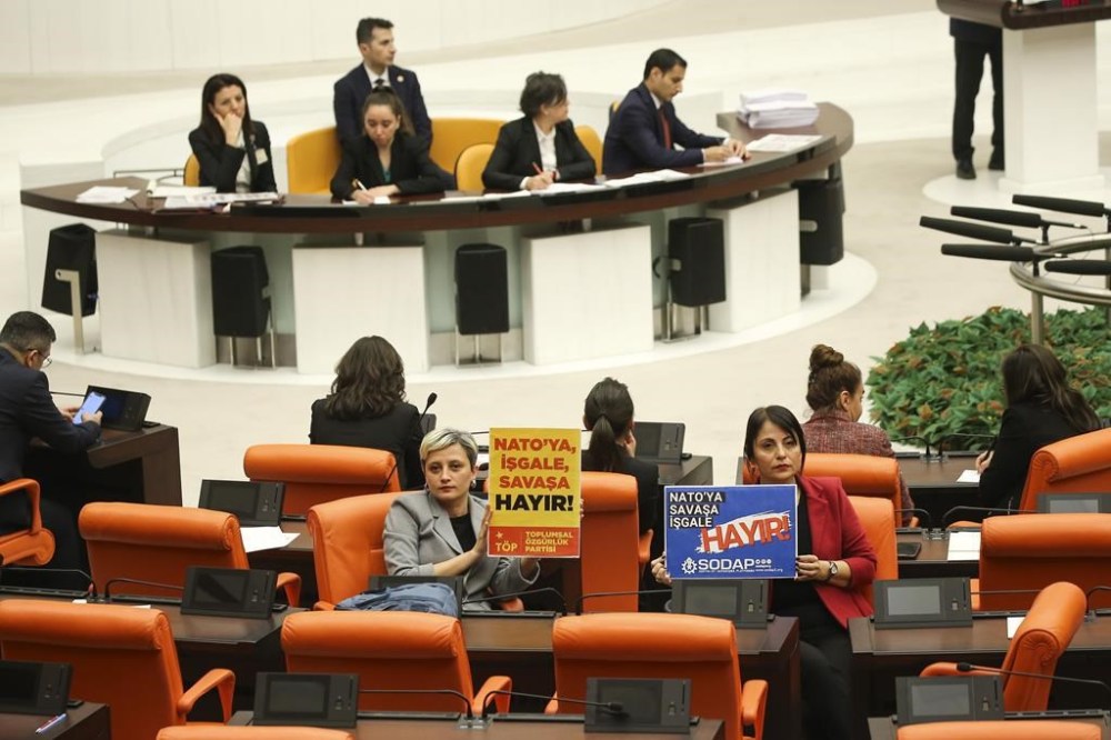 Turkish lawmakers from Toplumsal Ozgurluk or Social Freedom party, foreground left, and Sosyalist Dayanisma Platformu or Socialist Solidarity Platform hold posters that read in Turkish: