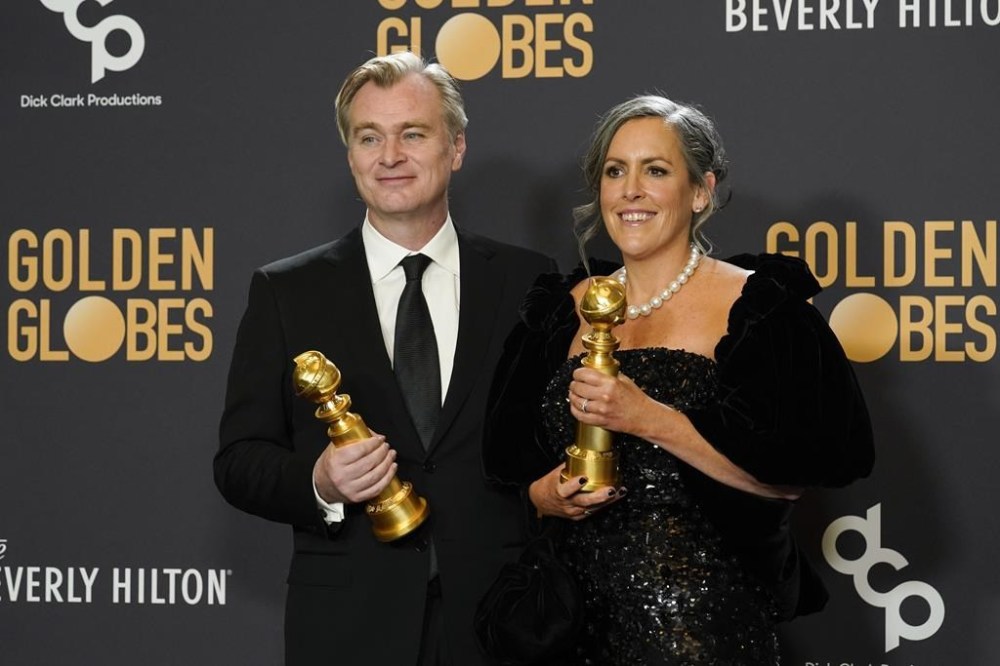 Christopher Nolan, left, and Emma Thomas pose in the press room with the award for best motion picture, drama for