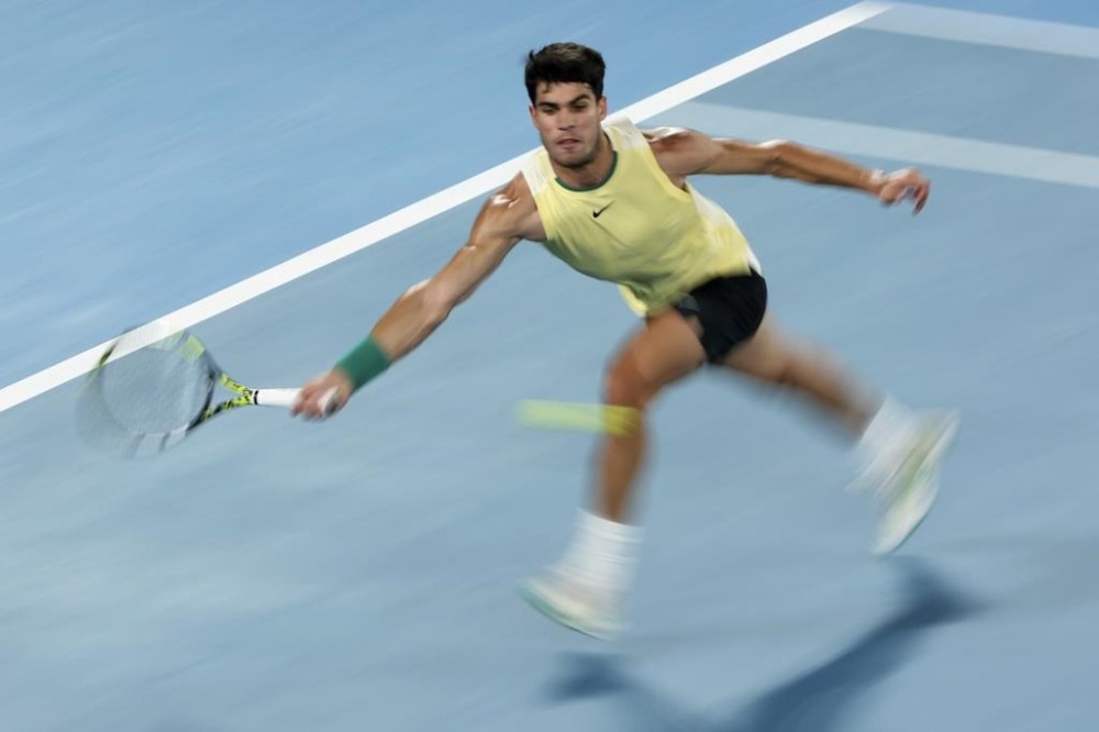 Carlos Alcaraz of Spain plays a forehand return to Alexander Zverev of Germany during their quarterfinal match at the Australian Open tennis championships at Melbourne Park, Melbourne, Australia, Wednesday, Jan. 24, 2024. (AP Photo/Asanka Brendon Ratnayake)