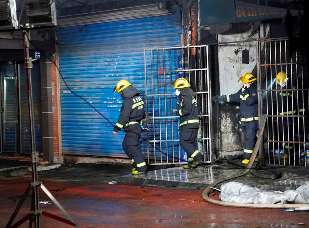 Firefighters work at the site of a building fire in Xinyu City, east China's Jiangxi Province, Wednesday, Jan. 24, 2024. Chinese state media say at least 39 people died and nine others were injured after a fire broke out in southeastern Jiangxi province. State broadcaster CCTV reported that local authorities said that the fire broke out Wednesday afternoon. The building houses an internet cafe in the basement and tutoring centers on upper floors. Local government officials were deployed to the scene in addition to first responders. (Zhou Mi, Xinhua via AP)