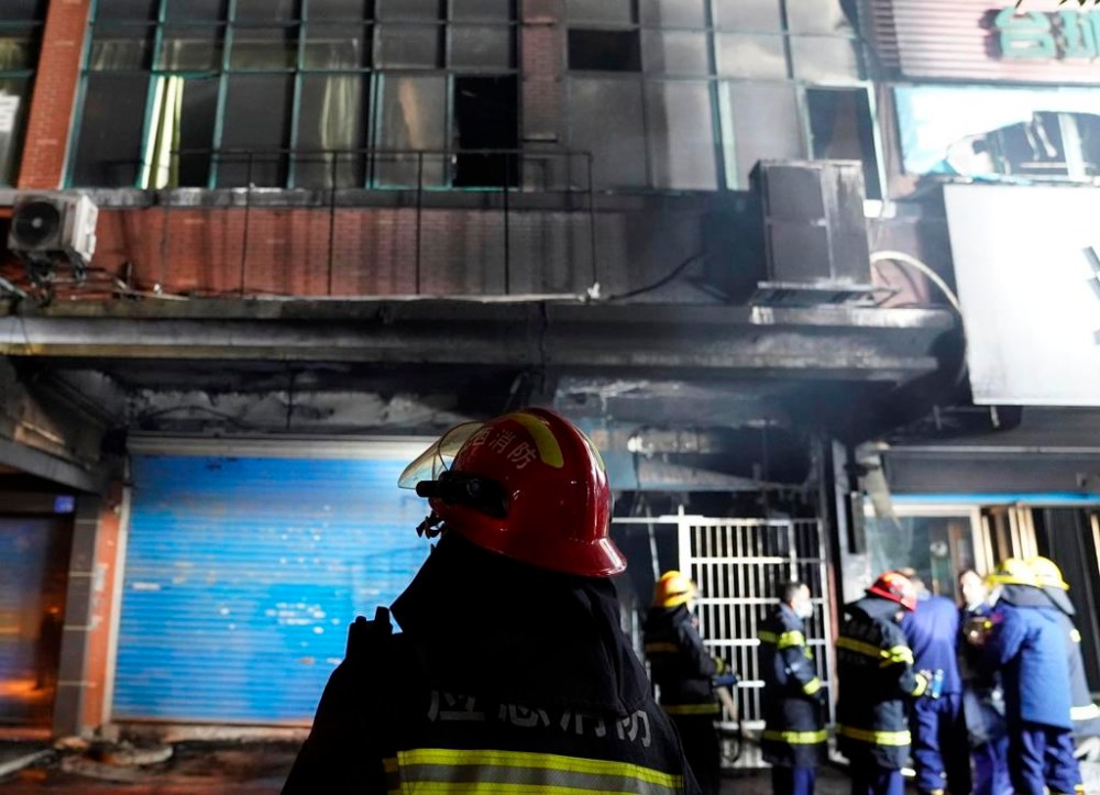 Firefighters work at the site of a building fire in Xinyu City, east China's Jiangxi Province, Wednesday, Jan. 24, 2024. Chinese state media say at least 39 people died and nine others were injured after a fire broke out in southeastern Jiangxi province. State broadcaster CCTV reported that local authorities said that the fire broke out Wednesday afternoon. The building houses an internet cafe in the basement and tutoring centers on upper floors. Local government officials were deployed to the scene in addition to first responders. (Zhou Mi, Xinhua via AP)