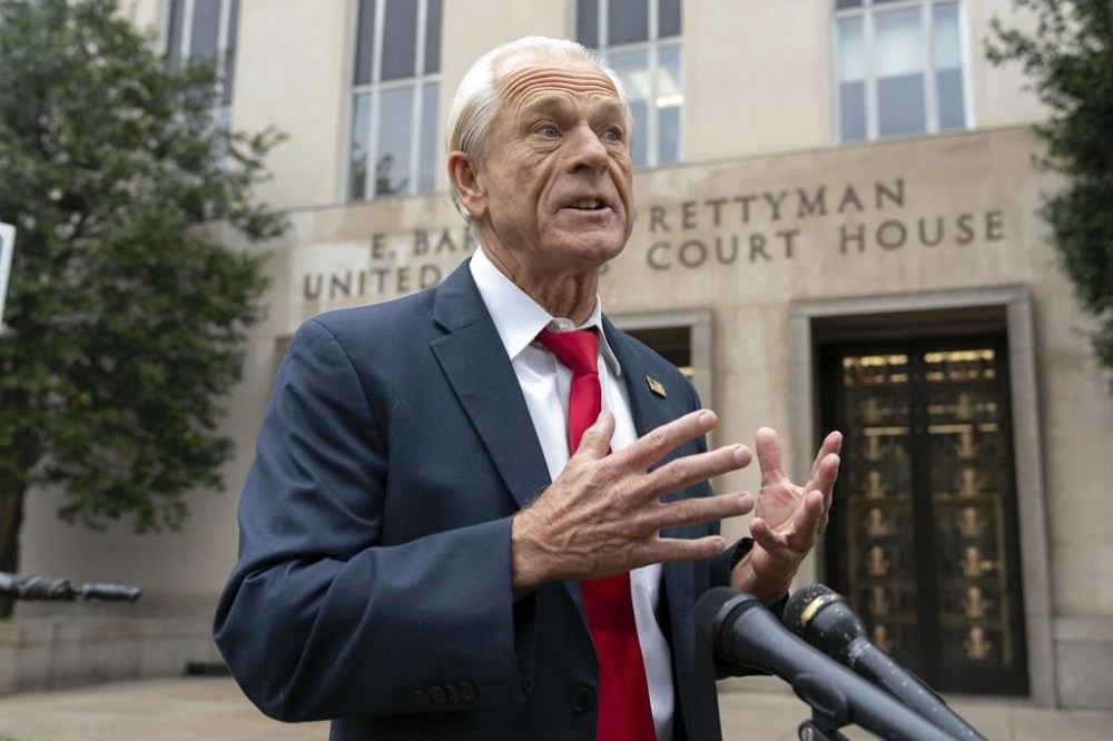 Former Trump White House official Peter Navarro talks to the media as he arrives at U.S. Federal Courthouse in Washington, Thursday, Jan. 25, 2024. (AP Photo/Jose Luis Magana)