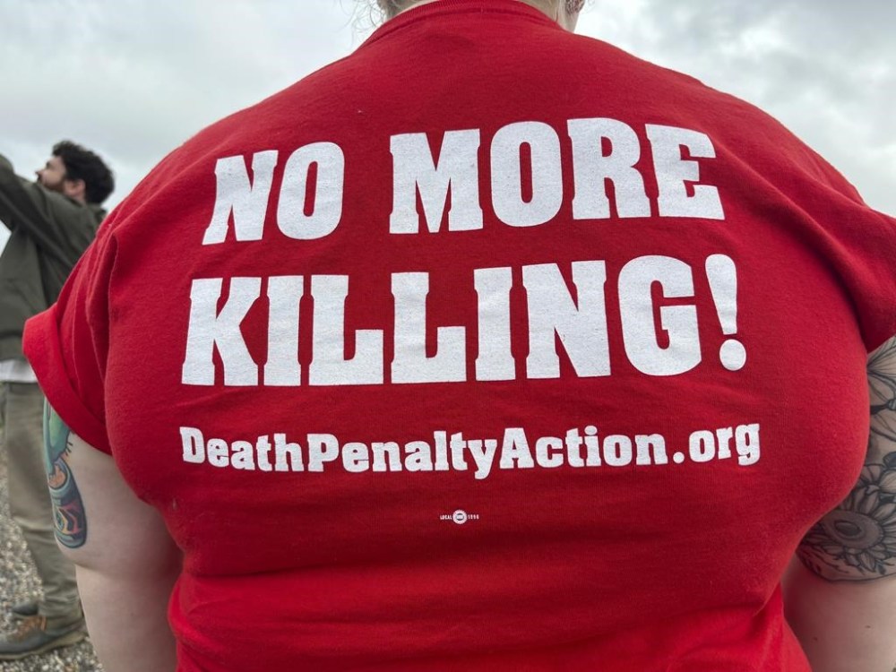 Anti-death penalty activists place signs along the road heading to Holman Correctional Facility in Atmore, Ala., ahead of the scheduled execution of Kenneth Eugene Smith on Thursday, Jan. 25, 2024. The state plans to put Smith to death with nitrogen gas, the first time the new method has been used in the United States. (AP Photo/Kim Chandler)