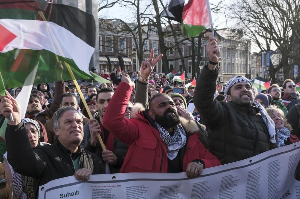 Pro-Palestinian activists react near the International Court of Justice, or World Court, in The Hague, Netherlands, Friday, Jan. 26, 2024. The United Nations' top court has decided not to throw out genocide charges against Israel for its military offensive in Gaza. That is part of a preliminary decision in a case that goes to the core of one of the world's most intractable conflicts. (AP Photo/Patrick Post)