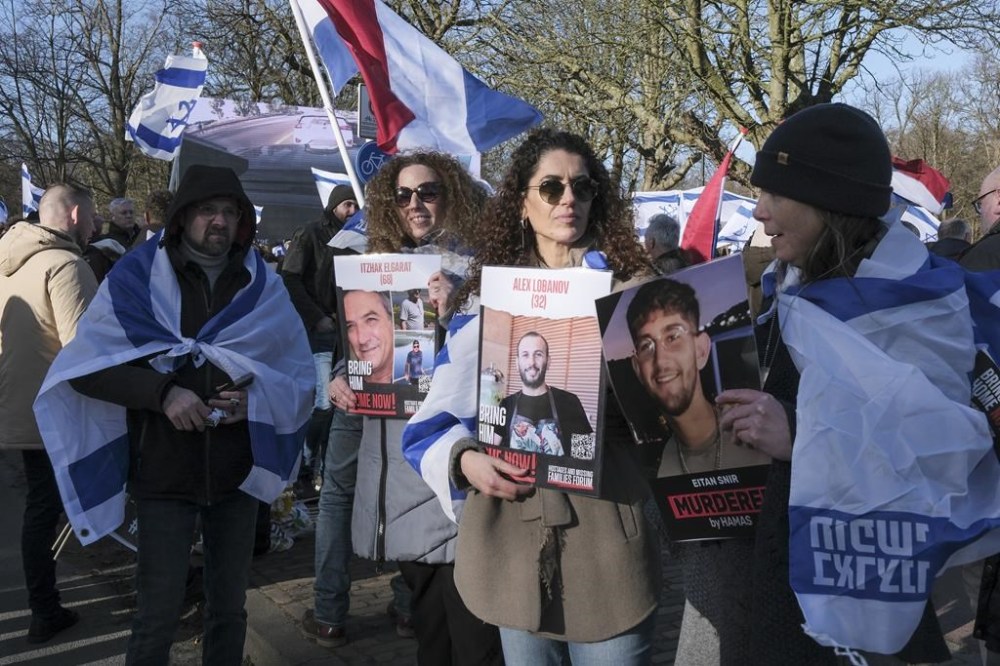Pro-Israel activists gather near the International Court of Justice, or World Court, in The Hague, Netherlands, Friday, Jan. 26, 2024. The United Nations' top court has decided not to throw out genocide charges against Israel for its military offensive in Gaza. That is part of a preliminary decision in a case that goes to the core of one of the world's most intractable conflicts. (AP Photo/Patrick Post)