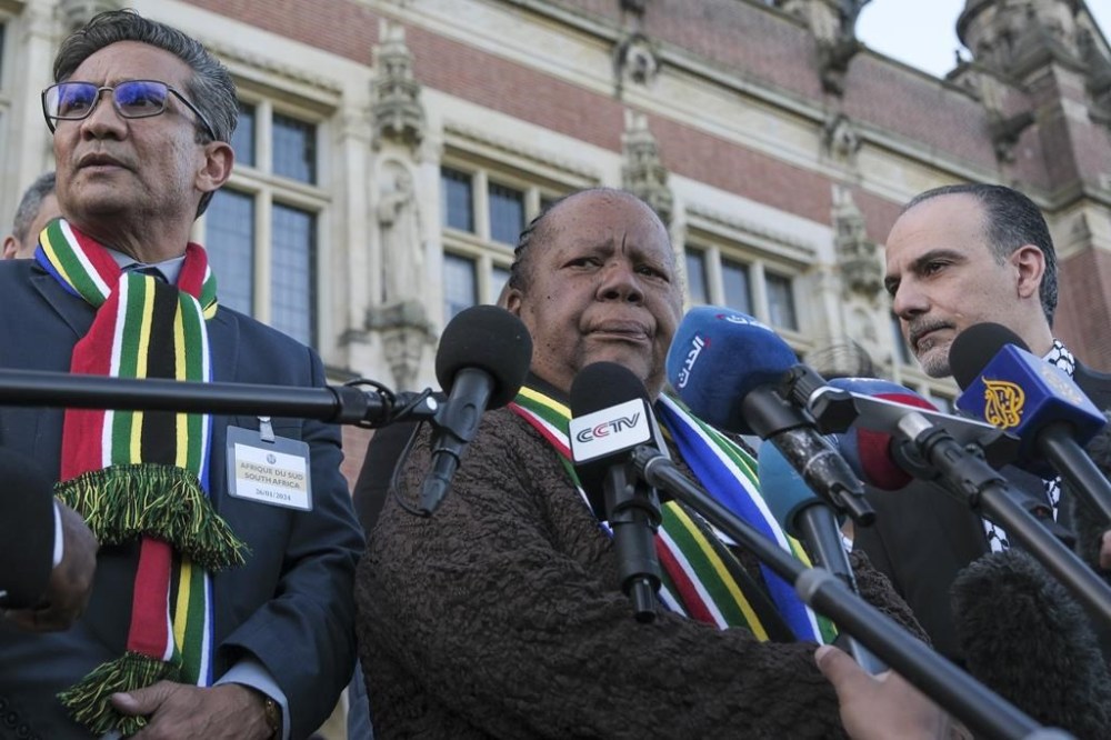 South Africa's Foreign Minister Naledi Pandor, centre, addresses reporters after session of the International Court of Justice, or World Court, in The Hague, Netherlands, Friday, Jan. 26, 2024. The United Nations' top court has stopped short of ordering a cease-fire in Gaza in a genocide case but demanded that Israel try to contain death and damage in its military offensive in the tiny coastal enclave. South Africa brought the case and had asked the court to order Israel to halt its operation. (AP Photo/Patrick Post)