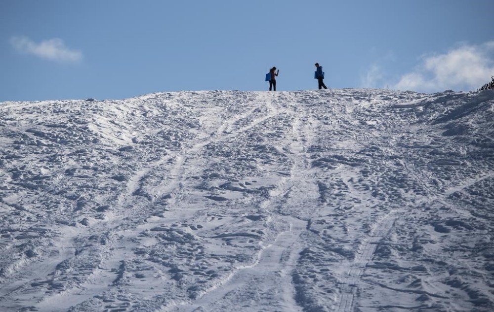 People get ready to toboggan down Carlington Hill in Ottawa after an overnight snowfall, on Wednesday, Jan. 27, 2021. A five-year-old boy is dead in southern Manitoba after being hit by a car while tobogganing. THE CANADIAN PRESS/Justin Tang