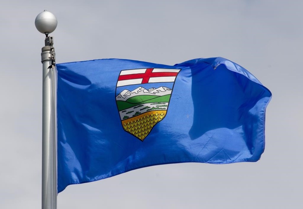 Alberta's provincial flag flies on a flag pole in Ottawa, Tuesday June 30, 2020. An air quality alert has been issued for an area east of Edmonton due to a fire at an oil lease site. THE CANADIAN PRESS/Adrian Wyld