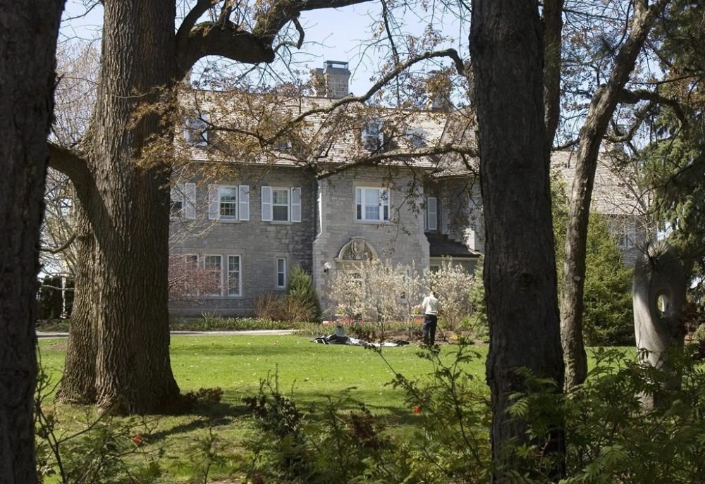 A gardener works on the grounds at the Prime Minister's residence at 24 Sussex Drive in Ottawa, Tuesday May 6, 2008. Turning Rideau Cottage into the permanent residence of the prime minister would come at the cost of creating staff offices and other