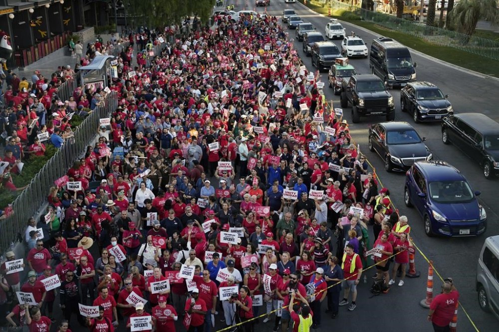FILE - Members of the Culinary Workers Union rally along the Las Vegas Strip, Aug. 10, 2023, in Las Vegas. The union representing hospitality workers says it has reached a tentative agreement with six more hotel-casinos in downtown Las Vegas and called off a strike deadline for another. The agreements averted a Monday, Feb. 5, 2024 morning walkout threat at several near-Strip and downtown properties as the city kicks off Super Bowl week. (AP Photo/John Locher, file)