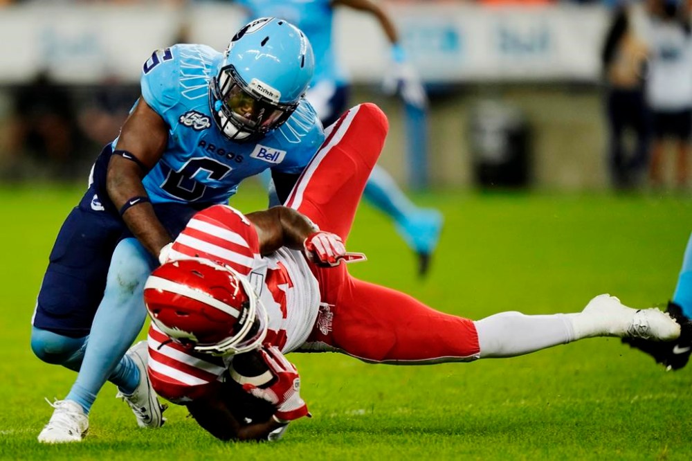 Toronto Argonauts defensive back Adarius Pickett (6) tackles Calgary Stampeders running back LeVante Bellamy (34) during first half CFL football action in Toronto on Friday, August 25, 2023. Pickett is on the move. According to a CFL source, the veteran American linebacker has agreed in principle to a deal with the Ottawa Redblacks once free agency begins Feb. 13. THE CANADIAN PRESS/Frank Gunn