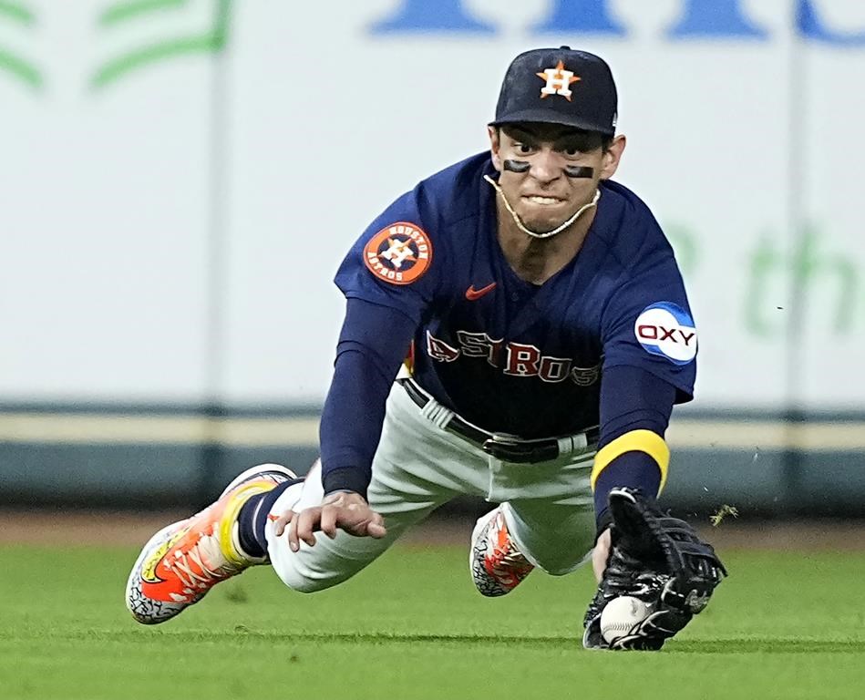 FILE - Houston Astros center fielder Mauricio Dubón dives while catching a fly ball by Kansas City Royals' Drew Waters during the fourth inning of a baseball game Sept. 24, 2023, in Houston. Houston utilityman Dubón went to a salary arbitration hearing Monday, Feb. 5, 2024. He asked for a raise from $1.4 million to $3.5 million and the Astros argued for $3 million in a case heard by John Woods, Jeanne Charles, and Janice Johnston. (AP Photo/David J. Phillip, File)