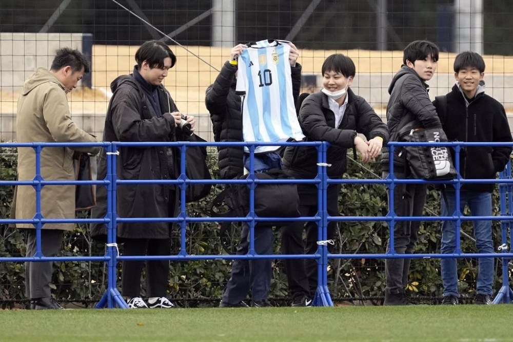 One of Inter Miami's fans holds a copy of Lionel Messi's Argentine national team uniform during a training session Tuesday, Feb. 6, 2024, in Chiba, near Tokyo. Inter Miami is facing Vissel Kobe in a friendly soccer match Wednesday. (AP Photo/Eugene Hoshiko)