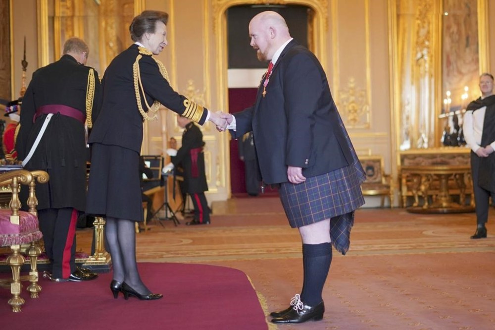 Britain’s Princess Anne, left, makes Opera tenor Nicholas Spence Officer of the Order of the British Empire, at Windsor Castle, in Windsor, England, Tuesday, Feb. 6, 2024. The honour recognises services to the rugby union football. (Yui Mok/PA via AP)