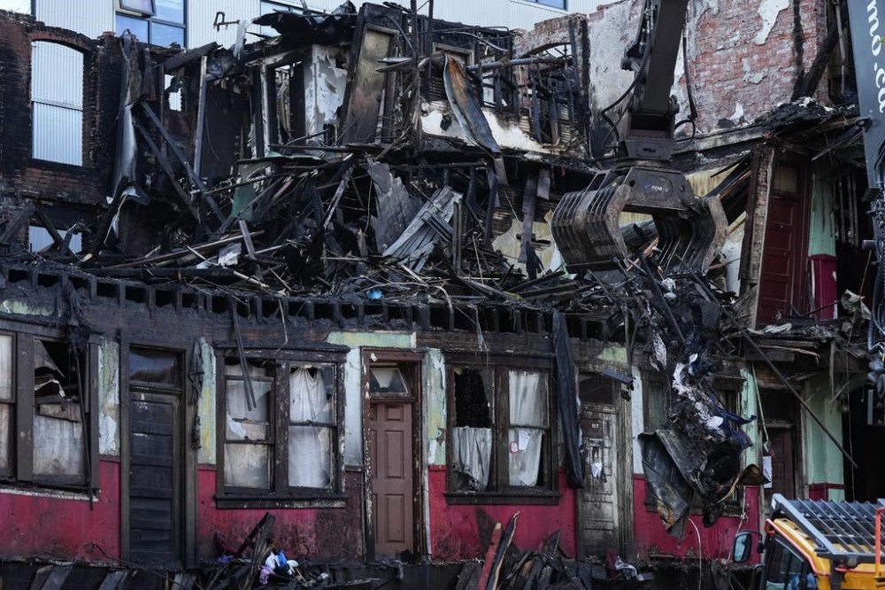 The society that operated the Vancouver supportive housing building where a fire killed two people two years ago says it fully supports the recommendations of a coroner's inquest. Debris falls to the ground as demolition resumes on the Winters Hotel after a body was found in the single room occupancy building, in Vancouver, B.C., Friday, April 22, 2022. THE CANADIAN PRESS/Darryl Dyck