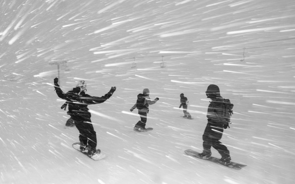 In this photo provided by the Mammoth Mountain Ski Area, snowboarders negotiate a downhill in Mammoth Lakes, Calif., on Monday, Feb. 5, 2024. (Andrew Miller/Mammoth Mountain Ski Area via AP)