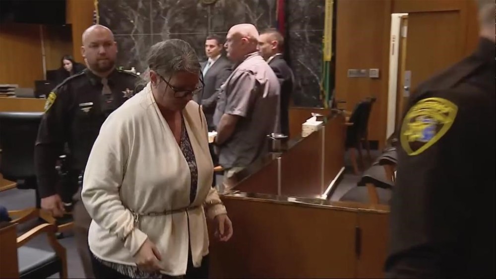 Jennifer Crumbley is taken into custody after a guilty verdict was read on Tuesday, Feb. 6, 2024 in Pontiac, Mich. The jury convicted Crumbley of involuntary manslaughter in a first-of-its-kind trial to determine whether she had any responsibility in the deaths of four students in 2021. Prosecutors say Jennifer Crumbley was grossly negligent when she failed to tell Oxford High School that the family had guns, including a 9 mm handgun that her son, Ethan Crumbley, used at a shooting range on the weekend before the Nov. 30, 2021, attack. (WJBK via AP, Pool)