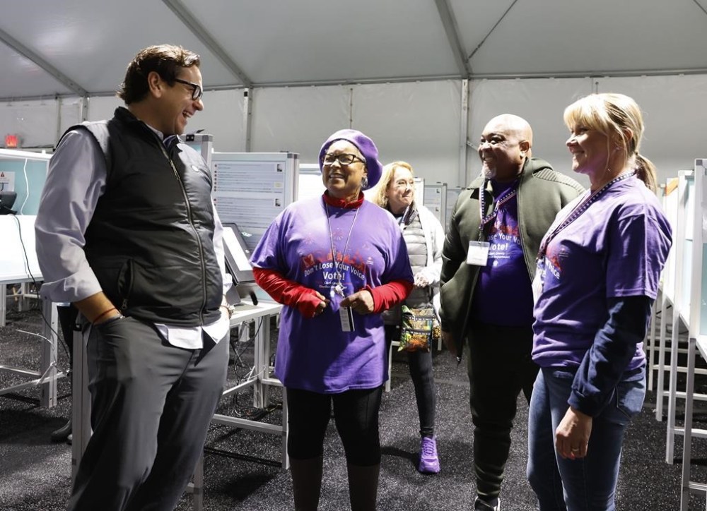 Nevada Secretary State Cisco Aguilar, left, chats with poll workers during primary voting Tuesday, Feb. 6, 2024, in Las Vegas. (Bizuayehu Tesfaye/Las Vegas Review-Journal via AP)