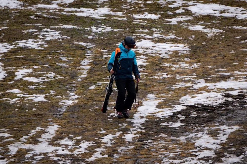 Skiers and snowboarders in British Columbia should expect unseasonably warm winters to become the new normal as climate change worsens, says a University of British Columbia associate professor in environmental sciences, amid a dismal ski season. A skier walks down a patchy ski slope at Whistler, B.C., Friday, Dec. 29, 2023. THE CANADIAN PRESS/Ethan Cairns