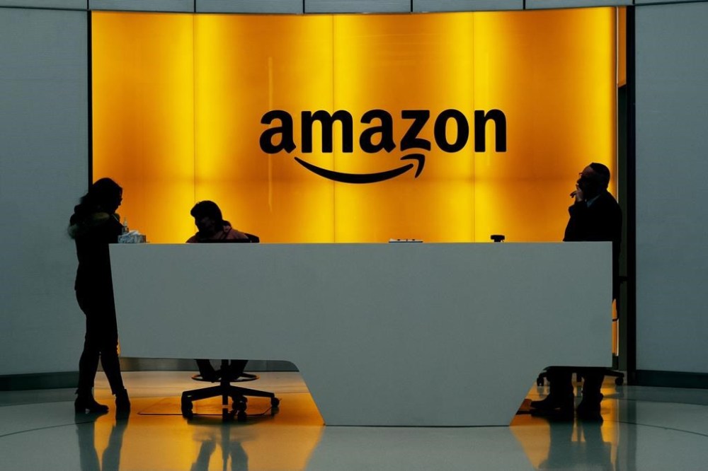 People stand in the lobby for Amazon offices in New York on Feb. 14, 2019. Representatives from Big Tech companies say a Liberal government bill that would begin regulating some artificial intelligence systems is too vague. THE CANADIAN PRESS/AP, Mark Lennihan