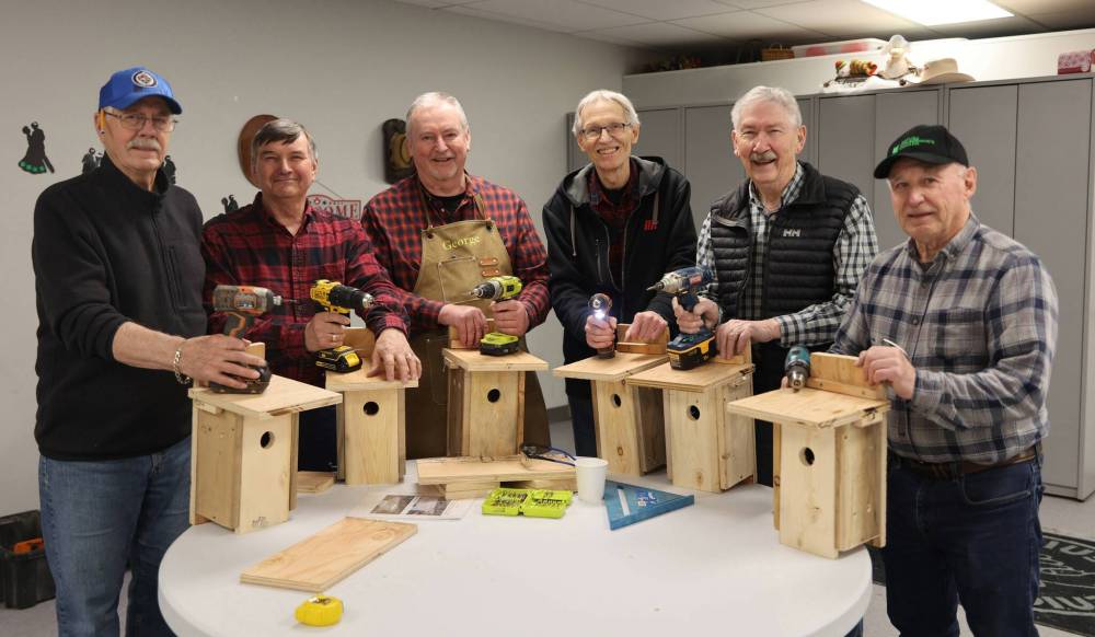 Six volunteers who took part in a blitz-build to construct 25 nest boxes for bluebirds and tree swallows stand behind some of their finished products on Thursday at Seniors for Seniors Co-op Inc. in Brandon. From left: Rollie MacKay, Wayne Yonda, George Michniewicz, Larry Grime, Lloyd McCabe and Brian Manns. (Michele McDougall/The Brandon Sun)