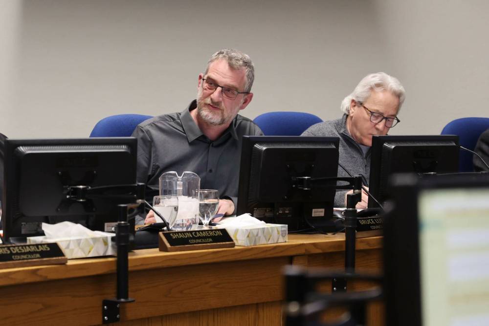 Coun. Bruce Luebke (Ward 6) and Coun. Glen Parker (Ward 9) listen to a presentation about community grant requests in council chambers during the City of Brandon's pre-budget session Monday evening. (Michele McDougall/The Brandon Sun)