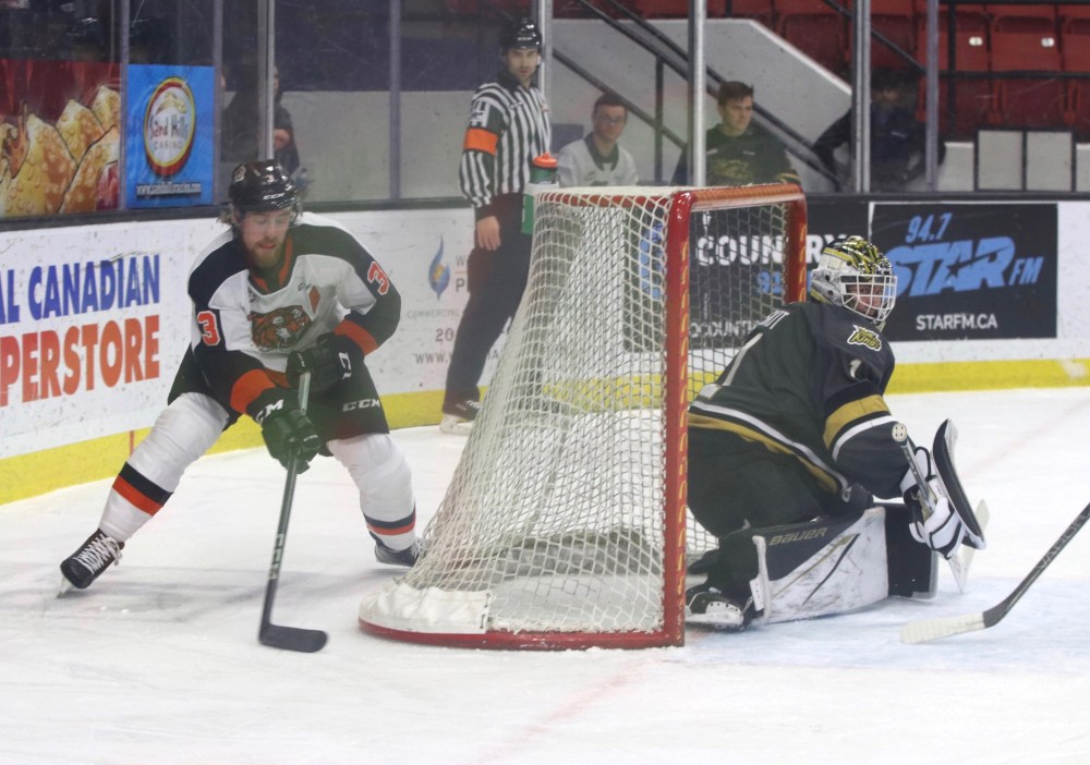 Medicine Hat Tigers defenceman Rhett Parsons (3) prepares to try a wrap-around as Brandon Wheat Kings goalie Ethan Eskit comes across the net to make the save during the first period in Western Hockey League action at Westoba Place on Sunday. (Perry Bergson/The Brandon Sun)