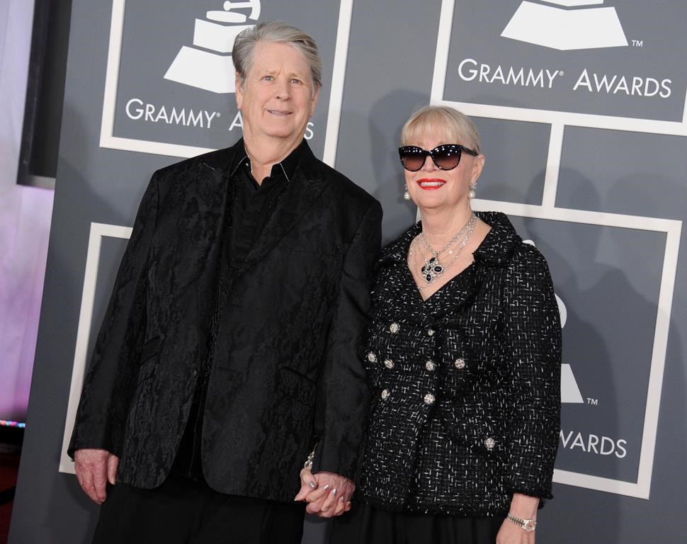 FILE - Musician Brian Wilson, left, and Melinda Ledbetter Wilson arrive at the 55th annual Grammy Awards on Sunday, Feb. 10, 2013, in Los Angeles. Ledbetter Wilson, the longtime wife and manager of Brian Wilson whom the Beach Boys co-founder often credited for stabilizing his famously troubled life, has died at age 77. (Photo by Jordan Strauss/Invision/AP, File)