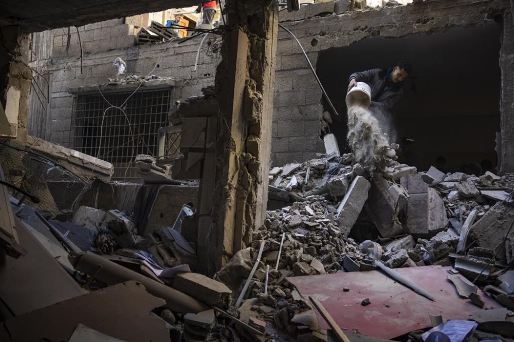 Palestinians look at the destruction after an Israeli strike in Rafah, southern Gaza Strip, Thursday, Feb. 8, 2024. (AP Photo/Fatima Shbair)